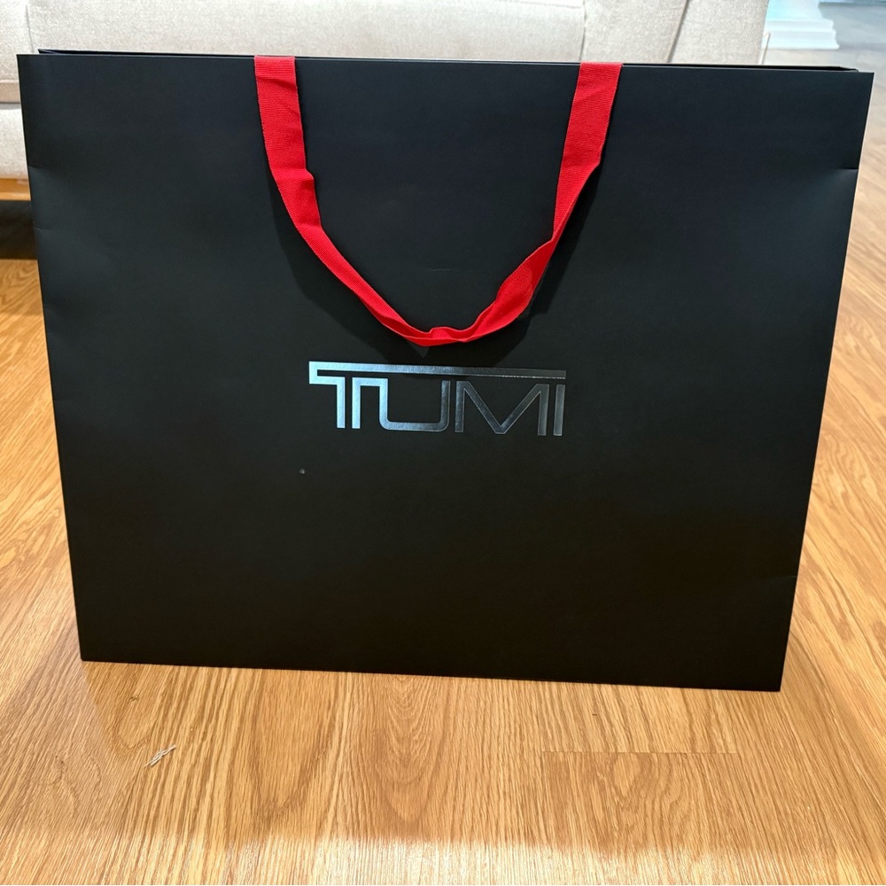 TUMI Black large carry Bag with Vibrant Red Strap brand new and clean